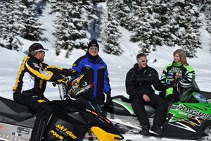 A group of snowmobilers smiling